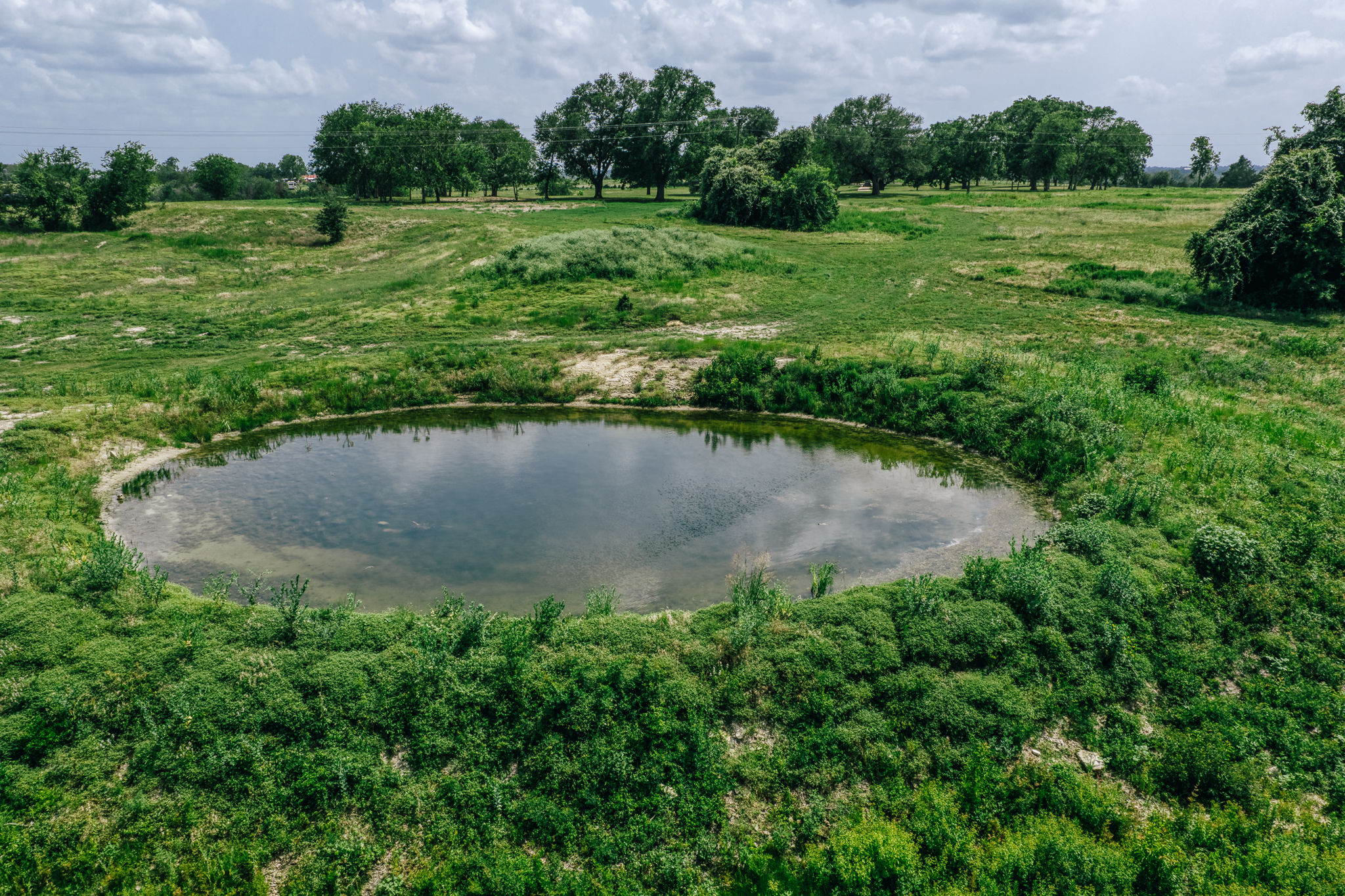 Aerial of land and water at The Clearing