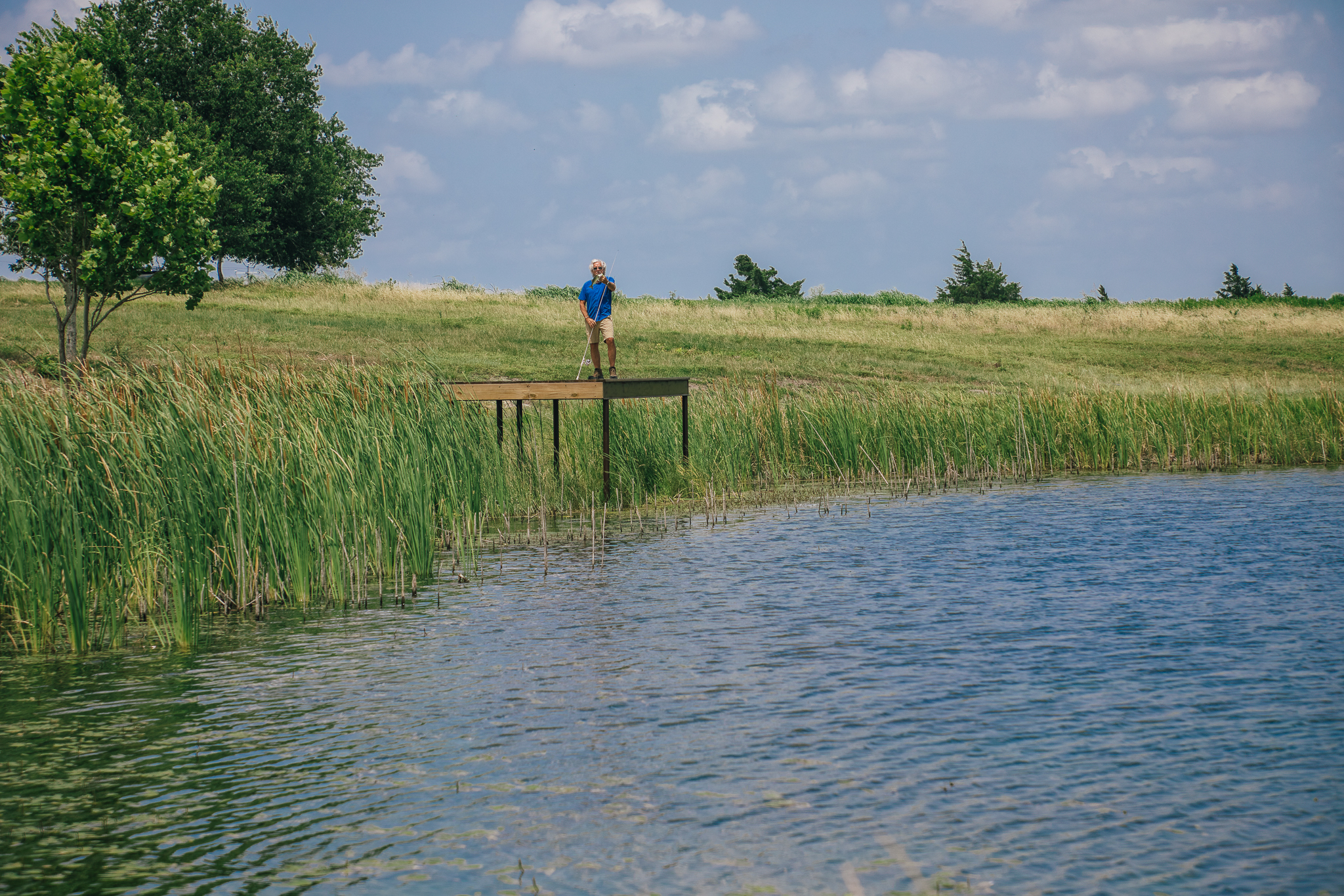 Man holding largemouth bass on dock at Lot 3